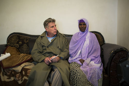 Minneapolis Star Tribune reporter Paul McEnroe speaks with Fadumo Hussein. This photo was taken a day after federal agents came to her home and arrested her youngest son, Guled Omar. Authorities say he was plotting with other young men to join ISIL. In 2007, another of Hussein’s sons, Ahmed Ali Omar, left the U.S. as part of the first wave of Somali-Americans in the Twin Cities to fight for Al-Shabab. Photo: Renee Jones Schneider/Star Tribune